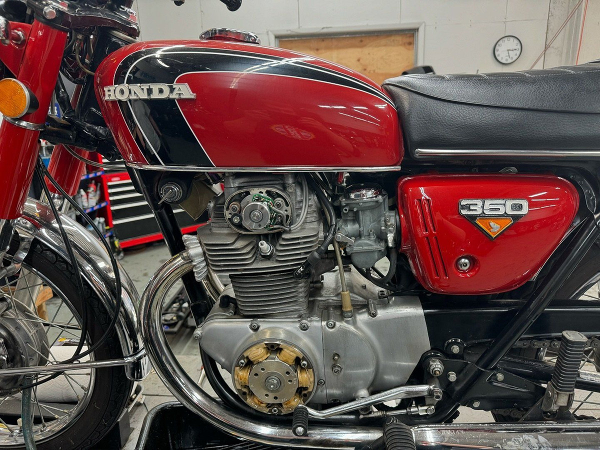 Honda 350 twin, red tank, in the shop